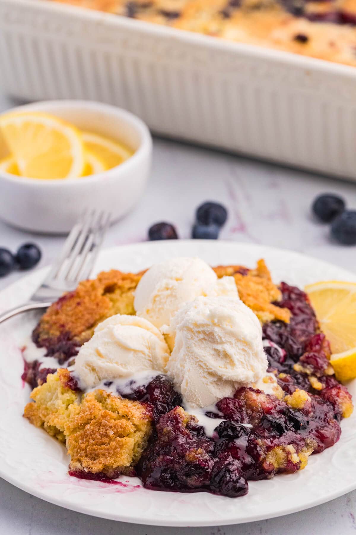 The recipe on a plate topped with vanilla ice cream.