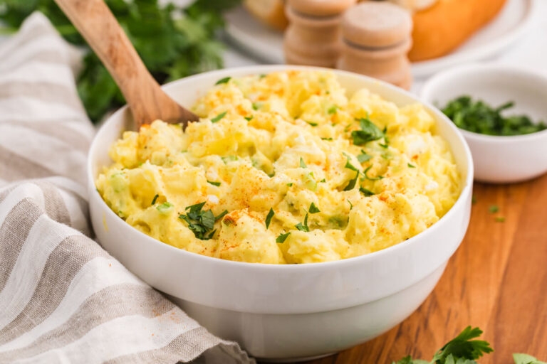 The recipe in a white bowl with a wooden spoon.