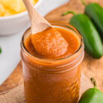 A jar of the recipe with a wooden spoon.