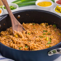 The recipe in a dark pan with a wooden spoon.