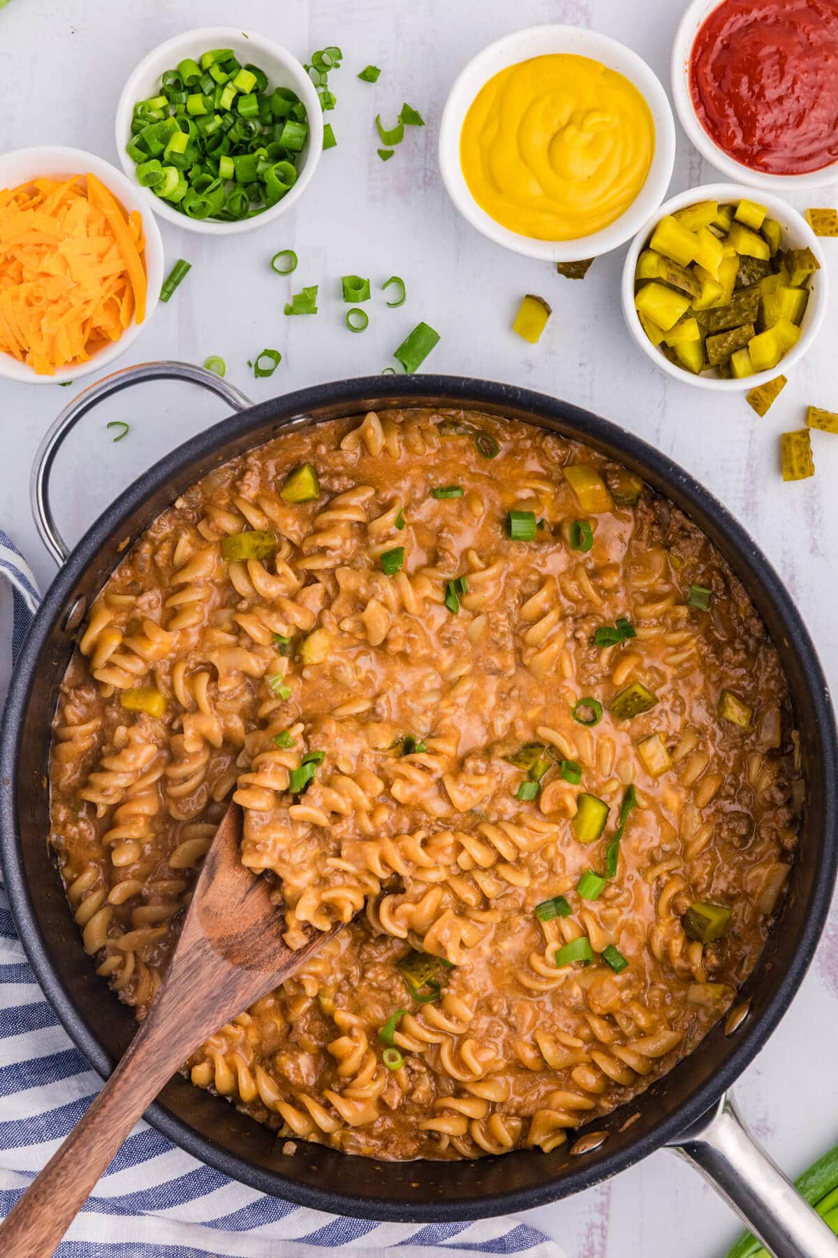 The recipe in a skillet with a wooden spoon.