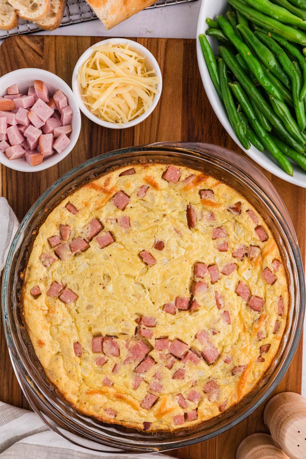 Ham and swiss impossible pie on a wooden surface.