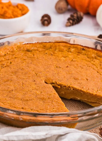 The pie in a pan with a slice cut out.