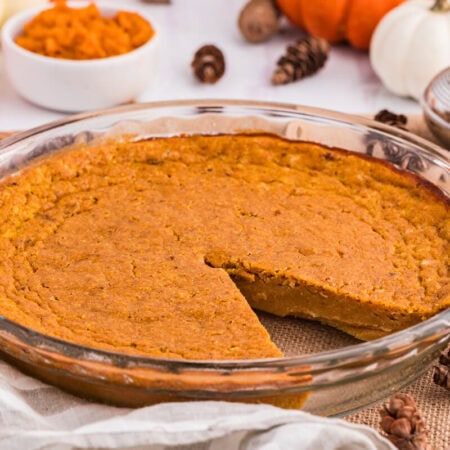 The pie in a pan with a slice cut out.