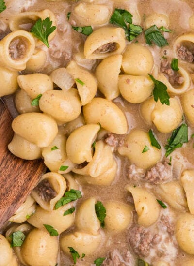 The recipe in a skillet with a wooden spoon.
