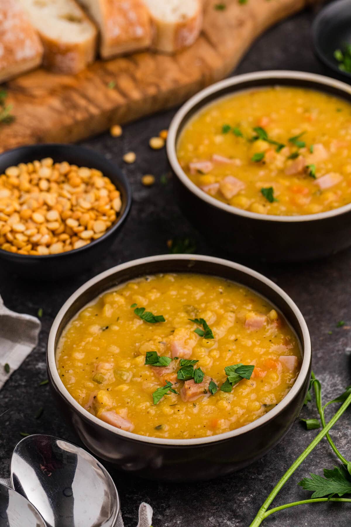 A black bowl of split pea soup.