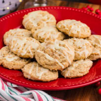 A festive plate of eggnog cookies decorated with icing, perfect for holiday gatherings.