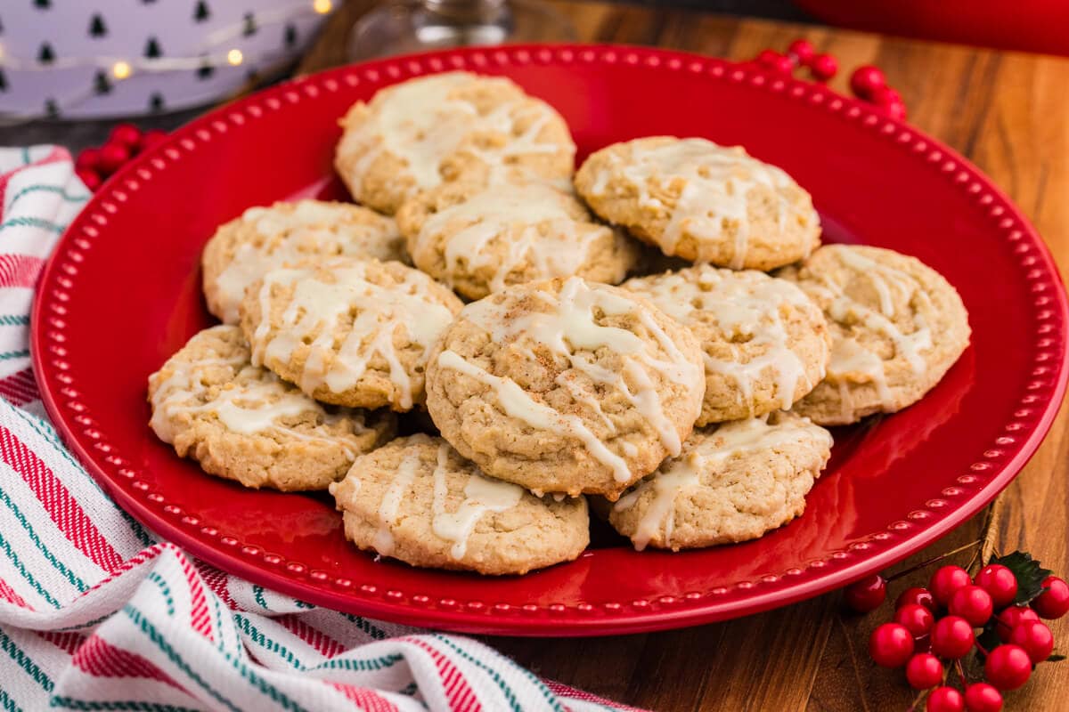 A festive plate of eggnog cookies decorated with icing, perfect for holiday gatherings.